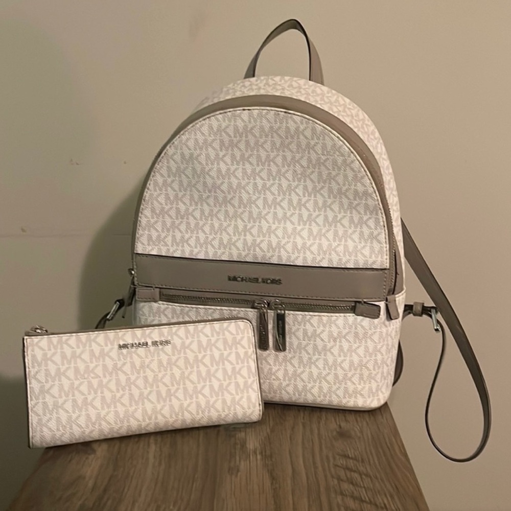 Michael Kors gray and white medium backpack with matching wallet.